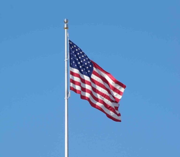 American Flag Waving in Clear Sky Stock Photo