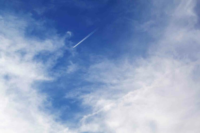 Blue Sky With Clouds and Chemtrail of Airplane