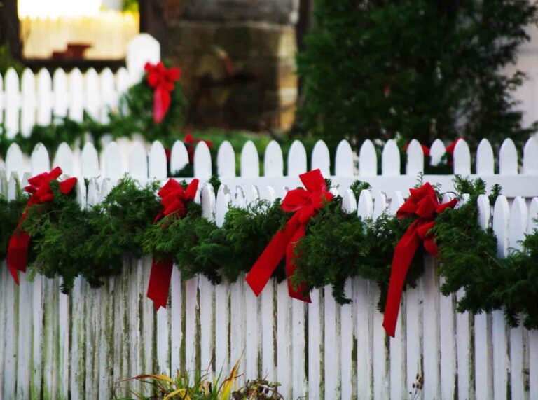 Christmas Garland Decorations Outdoors on Fence Stock Photo
