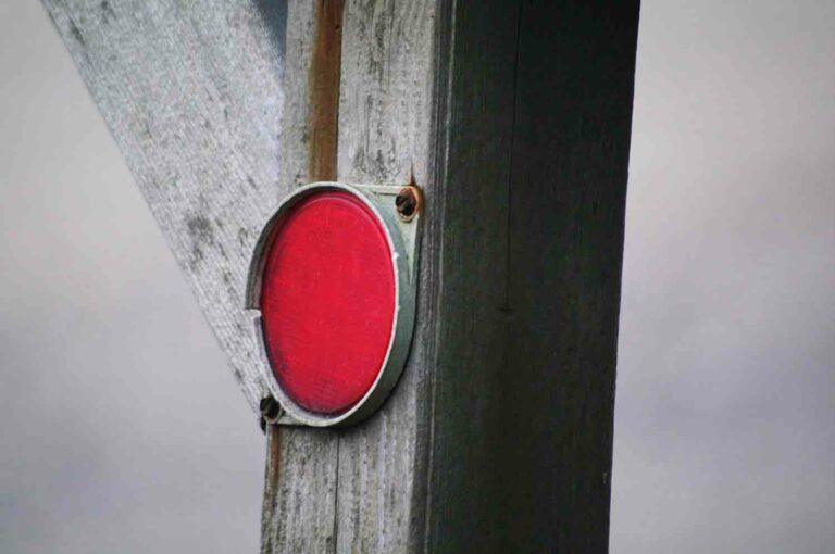 Red Reflector on a fence post stock photo