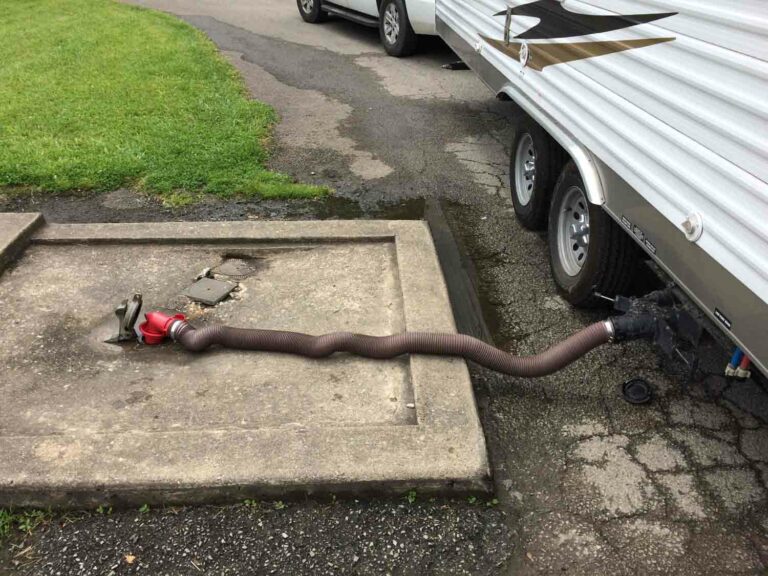 Stock Photo of an RV Sewer Hose Connected to Drain Black Water Tank