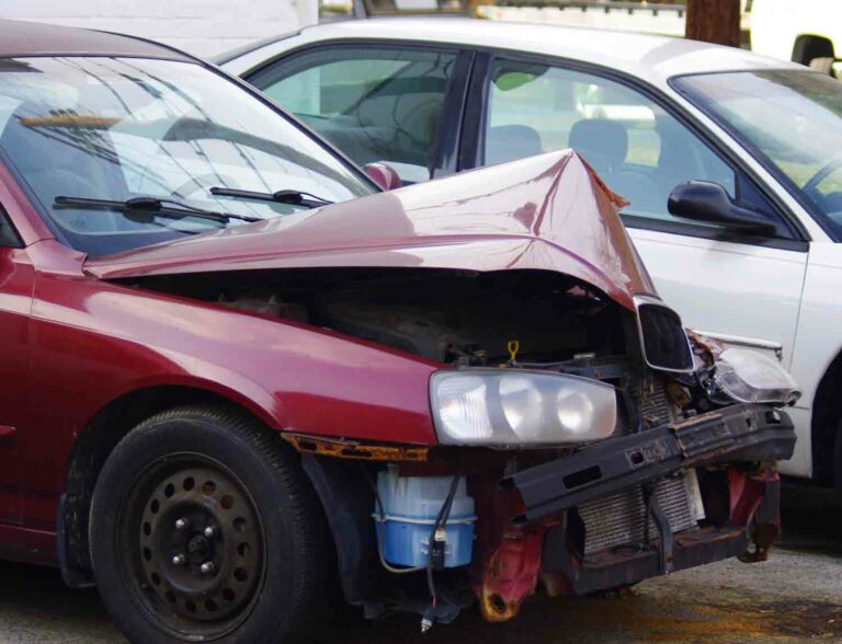 Wrecked Maroon Car After Accident That Smashed the Hood