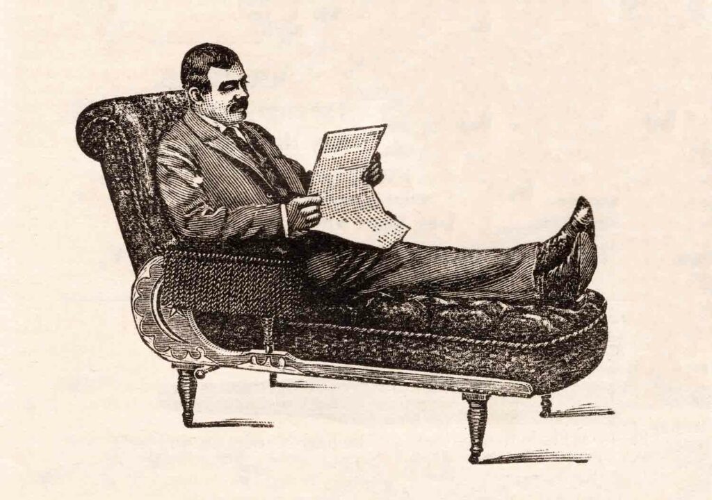 Man Reading Newspaper On Couch