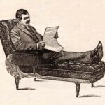 Man Reading Newspaper On Couch