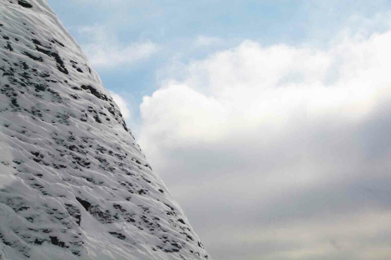 Snow Covered Stone Mountain With Clouds